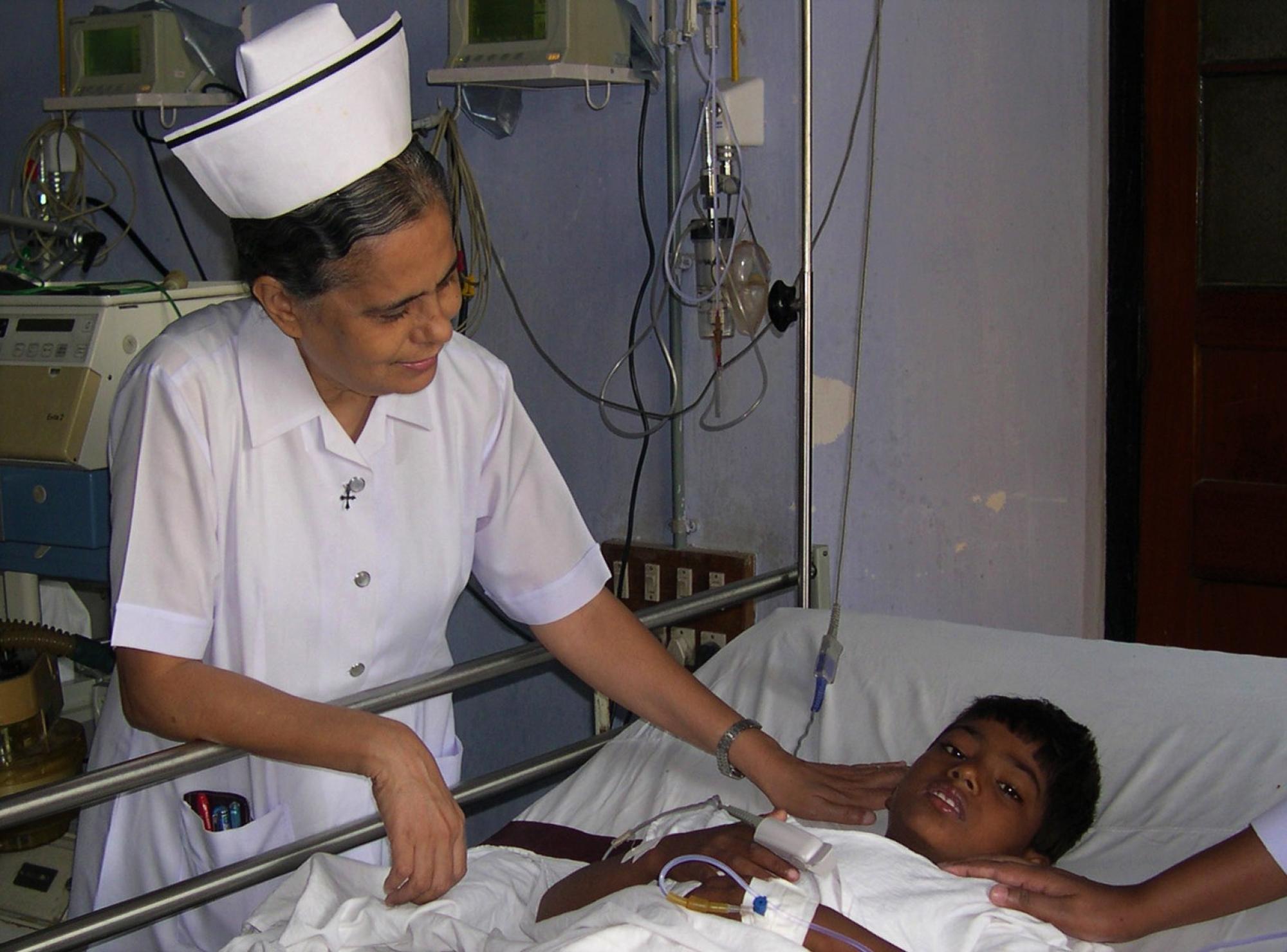 Sister Anne cares for a child in Holy Family Hospital, Patna