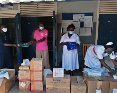 Sisters help to unpack PPE at the local hospital