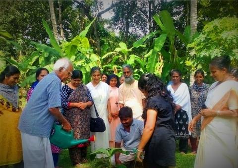 Planting a tree in our herbal garden in South India